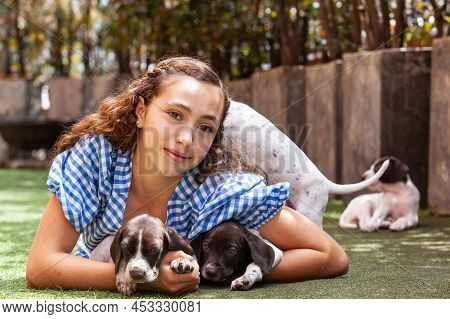 Beautiful Young Girl Having Fun With Her Small French Braque Puppies
