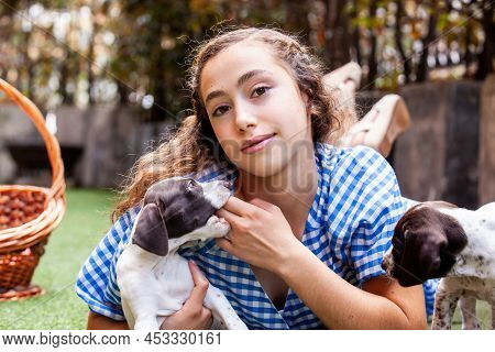 Beautiful Young Girl Having Fun With Her Small French Braque Puppies
