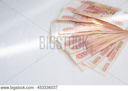 Russian Rubles On A White Background. Currency Exchange. Financial Crisis, Ruble Devaluation Concept