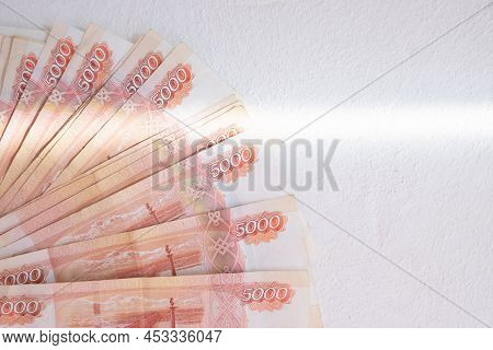 Russian Rubles On A White Background. Currency Exchange. Financial Crisis, Ruble Devaluation Concept