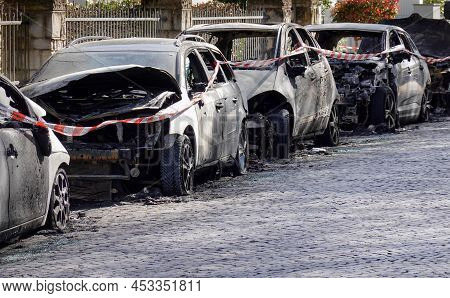 Burnt Out Car Wrecks Behind Police Tape In Residential Street After Vandalism In Germany