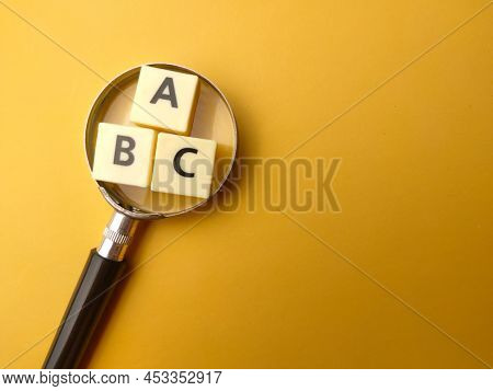 Mangnifying Glass And Toys Word With The Word Abc. Education Concept.