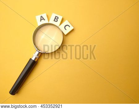 Mangnifying Glass And Toys Word With The Word Abc. Education Concept.