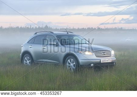 Novyy Urengoy, Russia - June 23, 2020: Luxury Crossover Infiniti Fx35 In A Foggy Field.