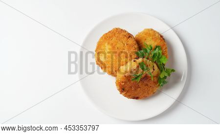 Plate With Chicken Cutlets. Fried Juicy  Cutlets On A White Plate Garnished With Parsley