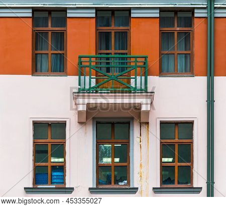 Balcony And Several Windows In A Row On The Facade Of The Modern Urban Apartment Building Front View