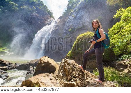 Woman Tourist And Dunhinda Waterfall In A Sunny Day In Sri Lanka