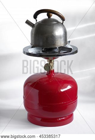 Kettle On The Compact Metal Gas Cylinder And Burner For Camping Stove.