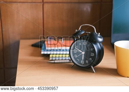 Coffee Mug, Laptop And Clock On Table Close Up