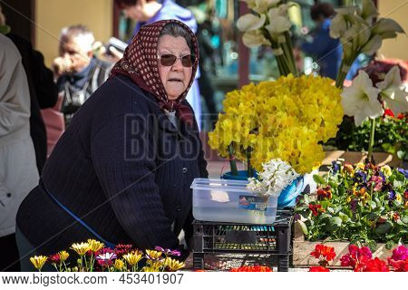 Sombor, Serbia - March 19, 2016: Selective Blur On A Merchant, A Senior Old Woman, Florist, Standing