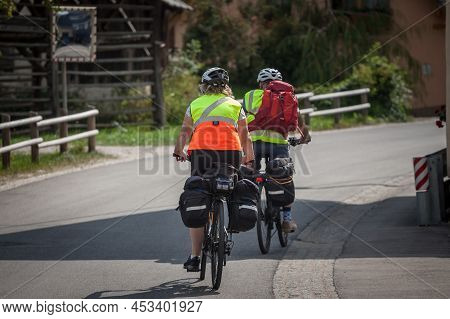 Stara Fuzina, Slovenia - September 12, 2021: Selective Blur On A Senior Couple Riding Bicycle Doing 