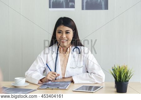 Women Doctor Using Laptop Tablet Telemedicine Vdo Call Conference With Patient. Women Doctor Write P
