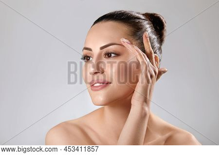 Beautiful Young Woman With Clean Perfect Skin. Portrait Of Beauty Model With Natural Nude Make Up An