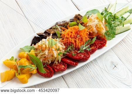 Assorted Vegetables In A Bowl. Sun-dried Tomatoes, Pickled Squash, Cabbage, Carrots And Cucumbers. O