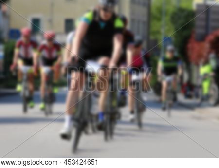 Intentionally Out Of Focus Of Cyclists During The Cycling Race As They Pedal On The Road And Sportsw
