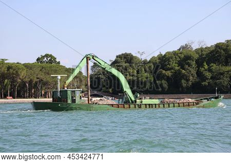 Industrial Boat With Crane To Load Construction Site Products On The Waterway
