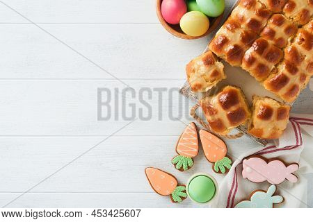 Easter Hot Cross Buns With Colored Eggs, Easter Gingerbread Rabbits And Cookies Over White Plank Woo