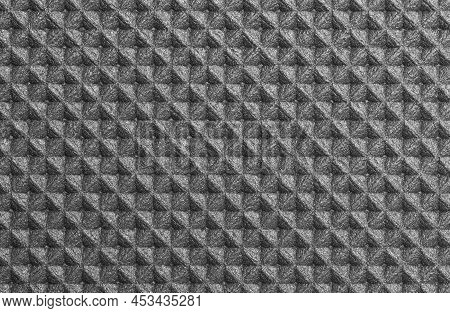A Geometric Pattern Of Foamed Polyurethane Mat In Shades Of Gray With Silver Highlights.