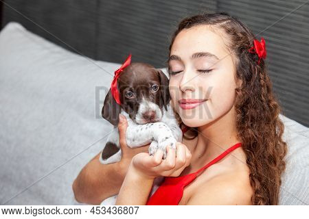 Beautiful Young Girl Dressed In Red With Her Small French Braque Puppy