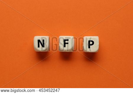 Abbreviation Nfp (nonfarm Payroll) Made Of Cubes With Letters On Orange Background, Flat Lay
