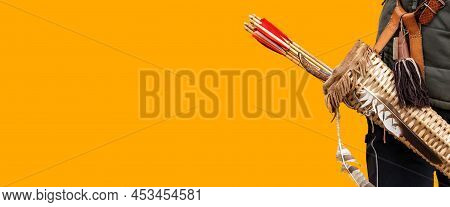 Close-up Of An Archer With A Vintage Quiver And Wooden Arrows Isolated On Orange Background With Cop