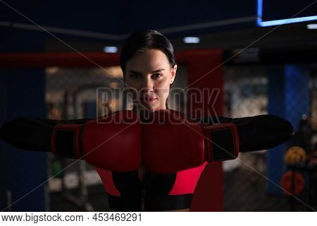 Young Sports Woman In Tracksuit And Putting Hands Together In Red Boxing Gloves.