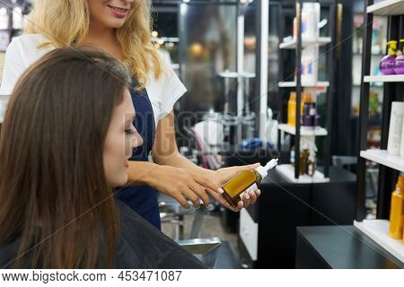 Hair Stylist Showing New Nourising And Conditioning Treatment To Client