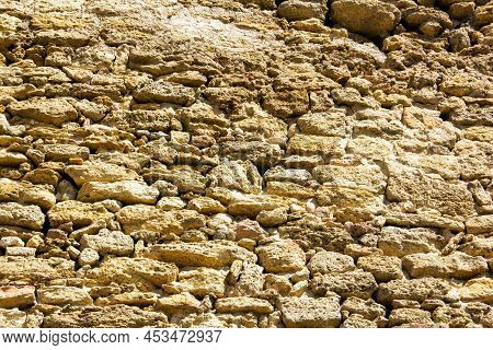 Background From A Stone Wall. Rakushnyak. Old Wall. Ukraine