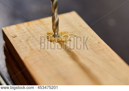 Close Up Of Drilling Into Wood With Screw Twisted Into Place, Metal Drill Bit