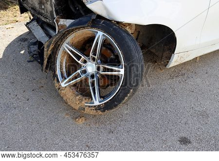 An Everted Car Wheel After An Accident. Wheel With Pieces Of Dirt.