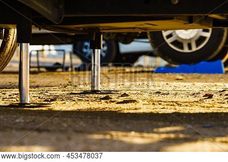 Auto Leveling System For Camper. Hydraulic Steady Leg In Use. Blue Leveler Ramp Chock Block For Rv I