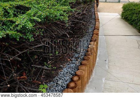 Park Threshing Beige Gravel Roads In The Sloping Terrain Have A Wooden Palisade Retaining Wall Above
