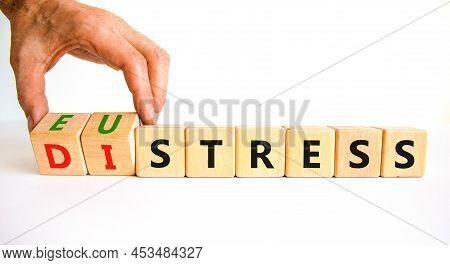 Eustress Or Distress Symbol. Psychologist Turns Cubes And Changes The Concept Word Eustress To Distr