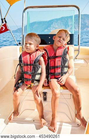 Blond Brothers In Life Jackets Feel Bored Sailing In Sea At Boat Trip In Marmaris. Toddler And Presc
