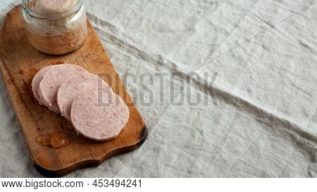 Homemade Jagdwurst On A Rustic Wooden Board, Side View. Copy Space.