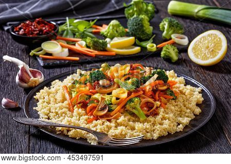 Quinoa Topped With Stir Fried Broccoli, Julienne Carrots, Sun Dried Tomatoes, Leek And Mushrooms On 