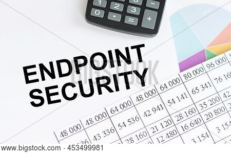 Text Endpoint Security On A Notepad On A Table Next To A Calculator And Financial Reports, A Busines