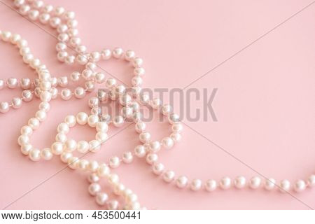 Pink Pastel Pearls Bead On Cute Rose Background With Copy Space. Soft Focus