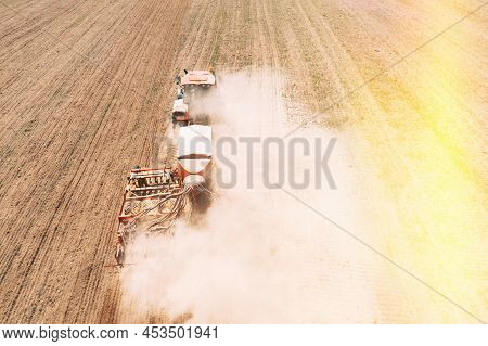 Elevated View Tractor With Seed Drill Machine Sowing Seeds For Crops In Spring Season. Beginning Of 