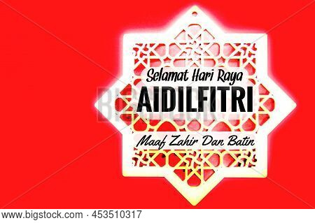 Eid Greeting Card With Red Background Islamic Decorative Pattern. (caption: Hari Raya Puasa, I Beg F