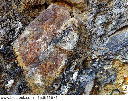 Geodesy. Stone Texture. The Rock Is Brown And Red. Mineral Background. Design From Natural Materials