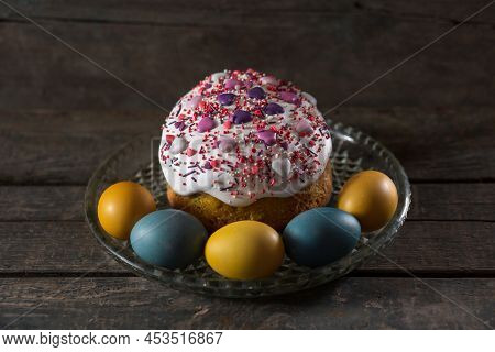 Easter Cake In A Transparent Dish, In The Foreground Are Painted Eggs In The Colors Of The Flag Of U