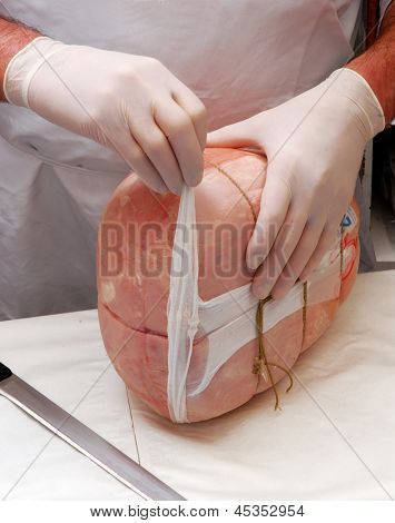 Trabalhando em uma porção de presunto presunto de carne de açougue.