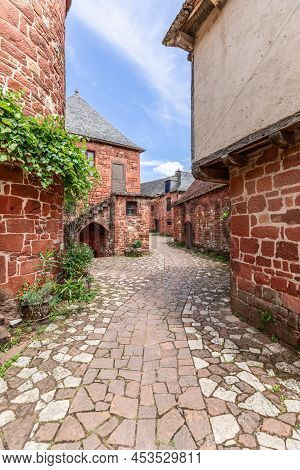 Deserted Stone Pavement winding Between Ancient Red Stone Houses Of Intricate Architecture In Collon