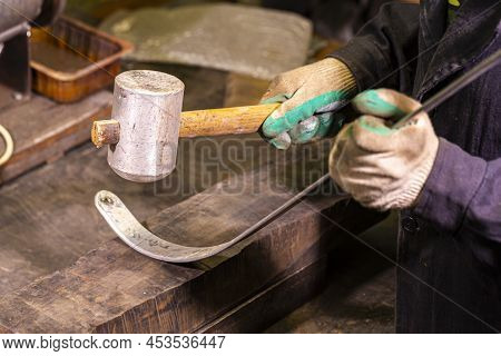 Hands Of Professional Fitter In Protective Gloves And Uniform Using Hammer For Metal Tape Precise Sm