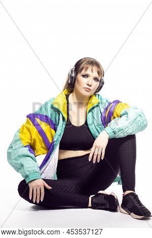 Young Winsome Caucasian Female Athlete Sportwoman In Fitness Sexy Outfit Wearing Wireless Headphones