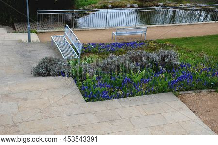 Between The Stairs Is A Waterfall With Stones And Boulders. Artificial Stream With A Waterfall Betwe