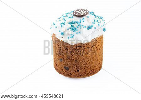 Russian Kulich With White Top And Blue Sprinkles. Chocolate Egg With Paschal Greeting Or Easter Accl