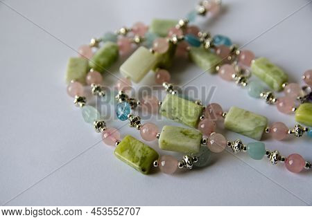 A Handmade Necklace Crafted From Pastel Coloured Beads Made From Aquamarine, Rose Quartz And Jade.  