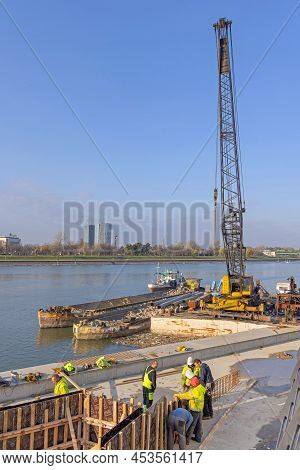 Belgrade, Serbia - November 25, 2021: Builders Workers At River Sava Waterfront Construction Site Su